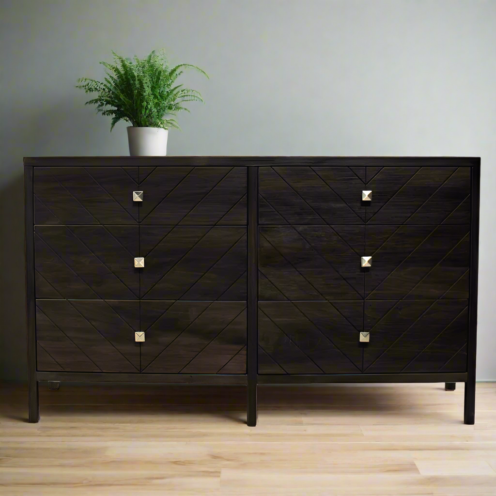 Dark wooden dresser with geometric pattern and metallic handles on a white background
