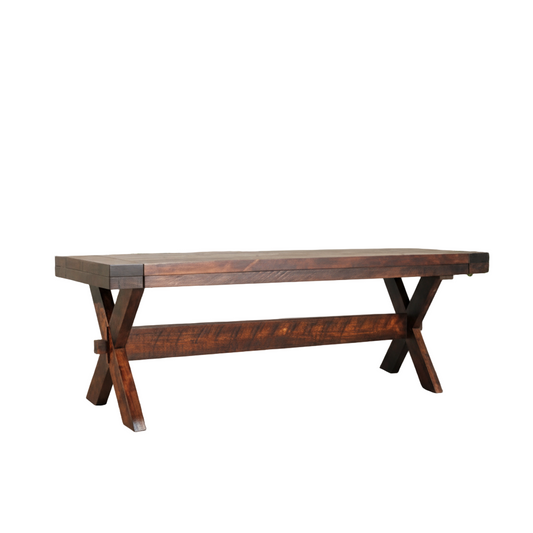 Wooden dining table in a bright room with large windows and plants.