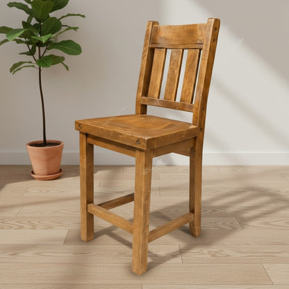 Wooden chair on a wooden floor with a plant in the background