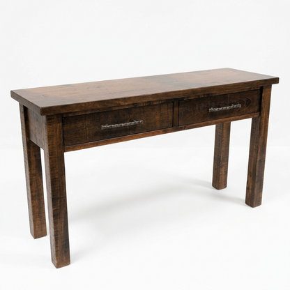 A rustic dark brown wooden writing desk with two drawers featuring decorative metal handles, set against a plain white background.