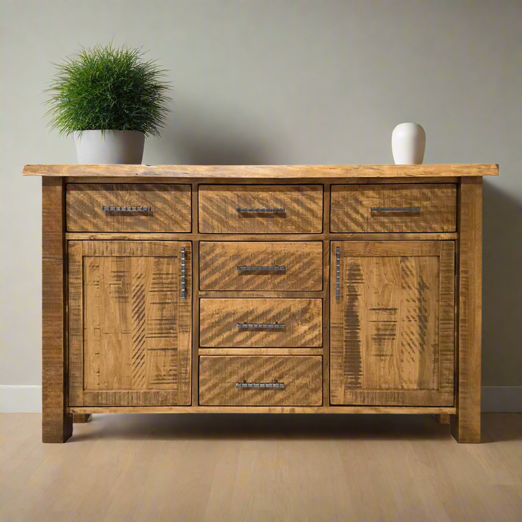 Wooden sideboard with multiple drawers and a door on a white background
