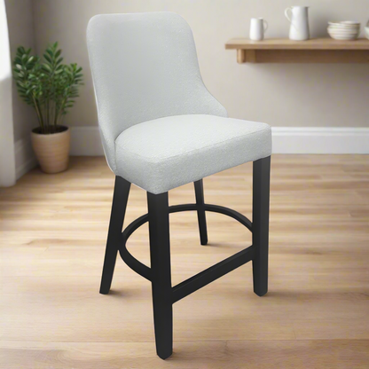 Gray cushioned bar stool with black legs on a white background