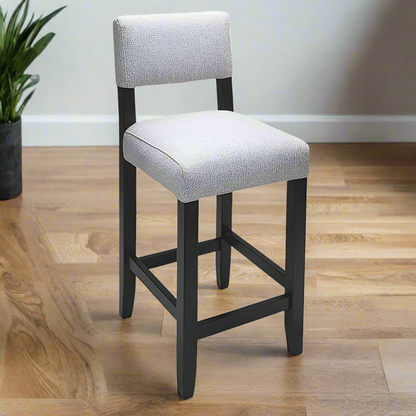 Gray cushioned bar stool with black legs on a white background