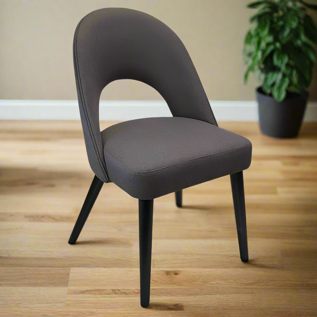 Gray upholstered chair with black legs on a white background