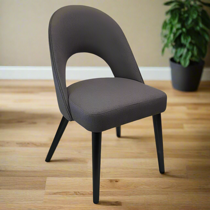 Gray upholstered chair with black legs on a white background