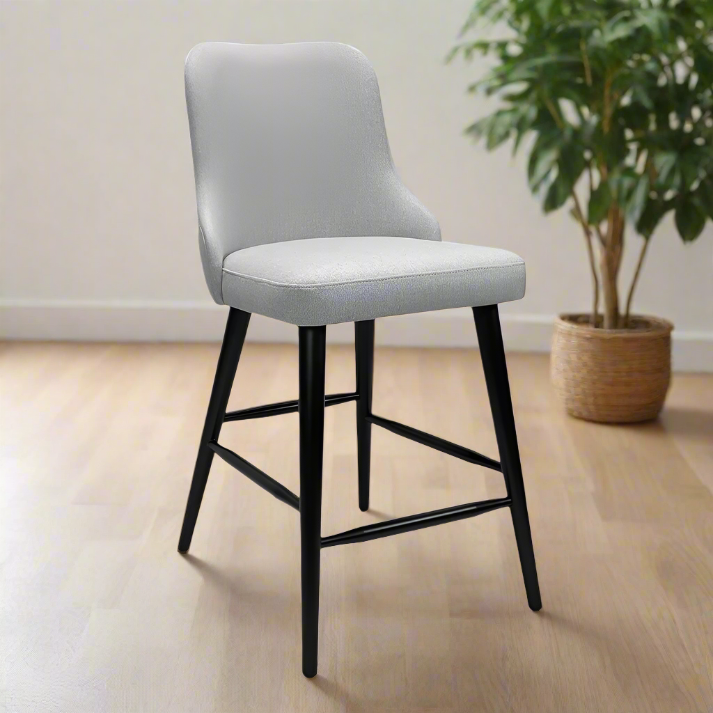 Gray cushioned bar stool with black legs on a white background