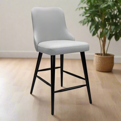 Gray cushioned bar stool with black legs on a white background