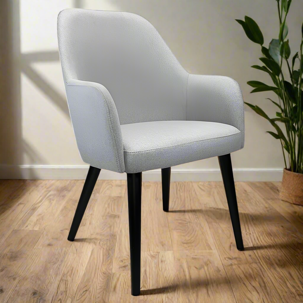 Gray upholstered chair with black legs on a white background
