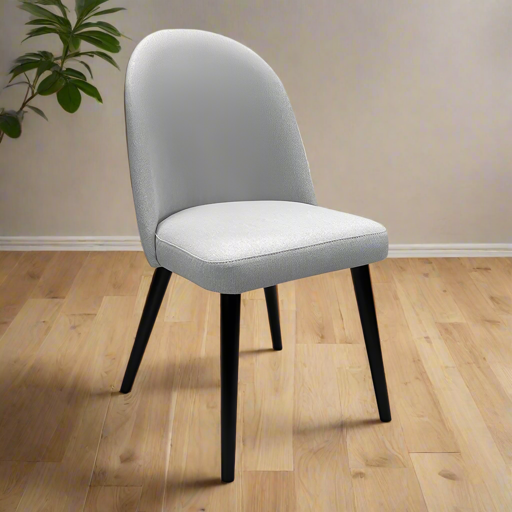 Gray upholstered chair with black legs on a white background