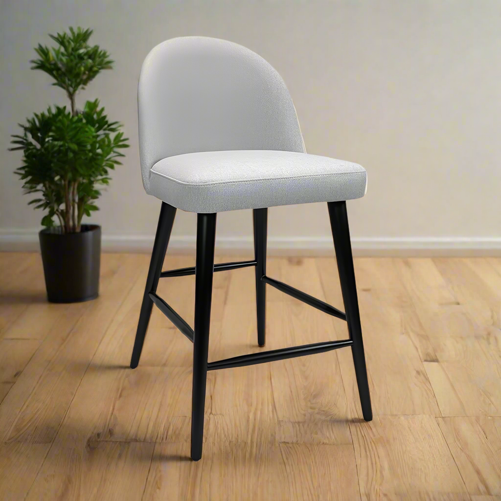 Gray cushioned bar stool with black legs on a white background