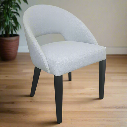 Gray upholstered chair with black legs on a white background