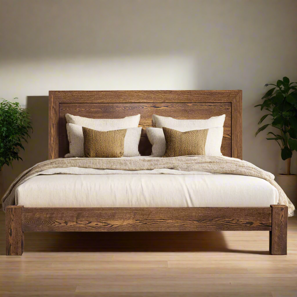 Wooden bed with white bedding and decorative pillows on a white background
