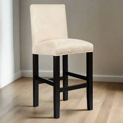 Bar stool with beige cushioned seat and black legs on a white background