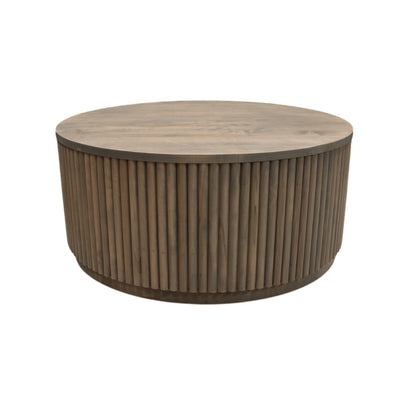Round wooden coffee table with ribbed cylindrical design on a white background