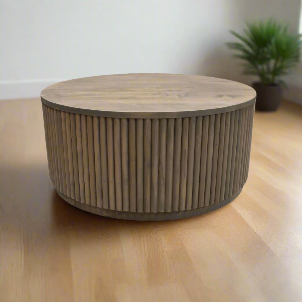 Round wooden coffee table with ribbed cylindrical design on a white background