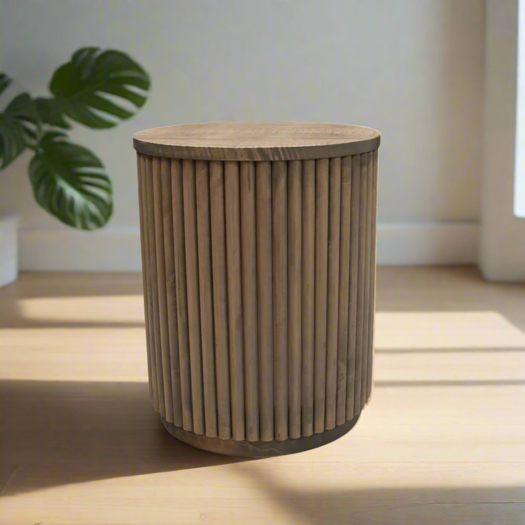 Wooden side table with a ribbed cylindrical design on a white background